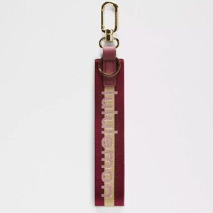 NWT Lululemon Never Lost Keychain Wordmark Deep Luxe/Gold/Bone One Size